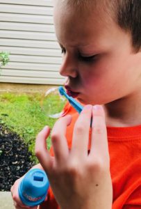 Boy blowing Fubbles bubbles