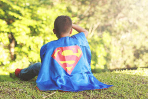 Boy in Superman cape, adoption fundraiser