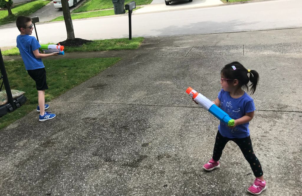 Siblings playing in the driveway